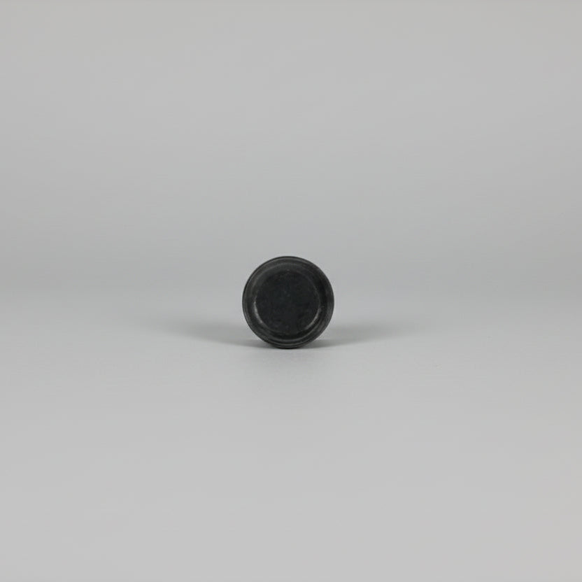 Black circular object on a white background